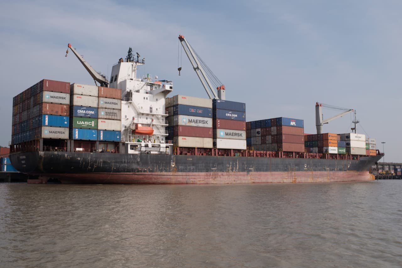 Container ship at river port